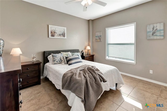 tiled bedroom featuring ceiling fan