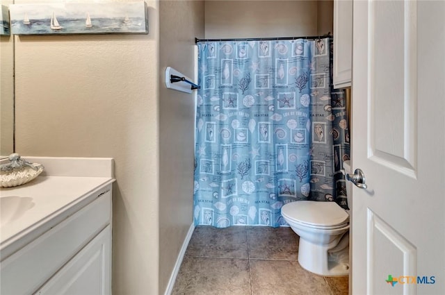 bathroom with tile patterned flooring, vanity, and toilet