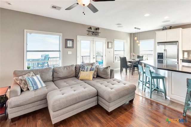 living room featuring french doors, dark hardwood / wood-style flooring, and ceiling fan