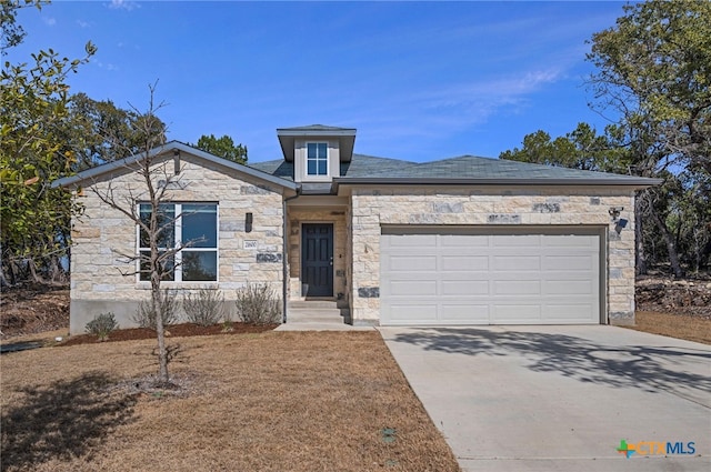 view of front facade with a garage, stone siding, and concrete driveway