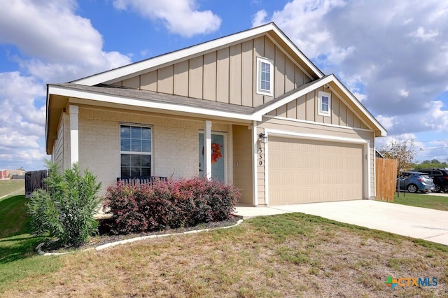 view of front of house featuring a garage and a front lawn