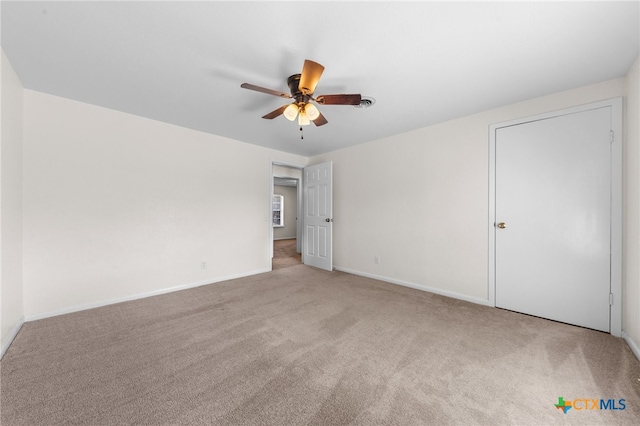 carpeted empty room with ceiling fan