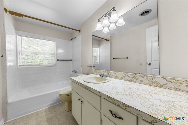 full bathroom featuring a wealth of natural light, vanity, tiled shower / bath combo, and toilet