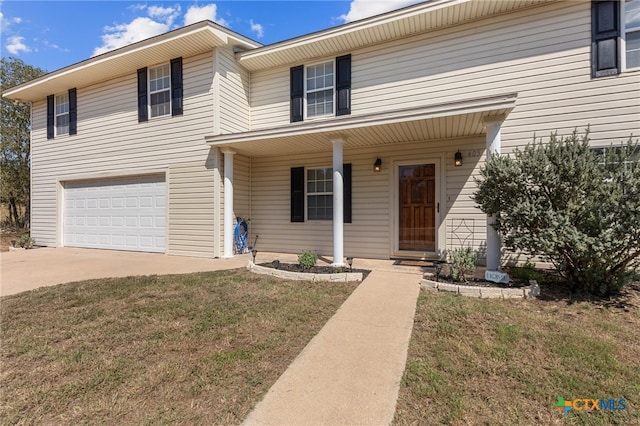 view of front of property featuring a garage and a front lawn