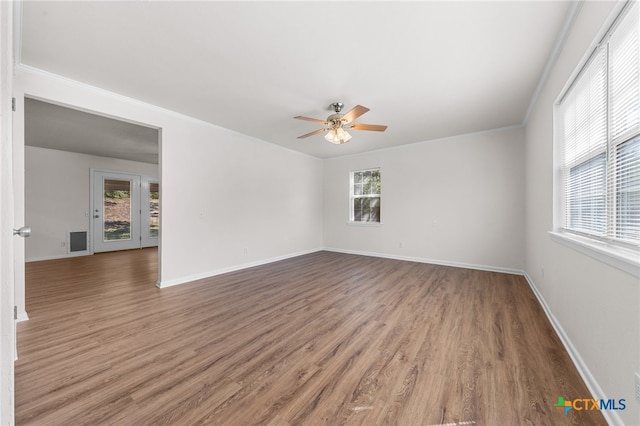 unfurnished room featuring ceiling fan, dark hardwood / wood-style floors, and ornamental molding