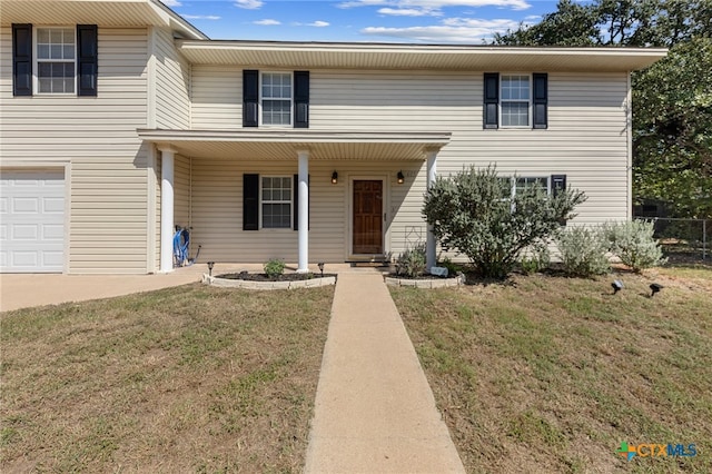 view of front of house featuring a front yard and a garage