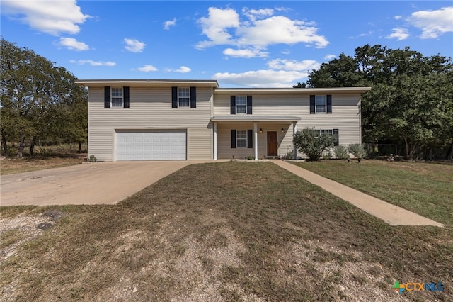 view of front of home with a garage and a front yard