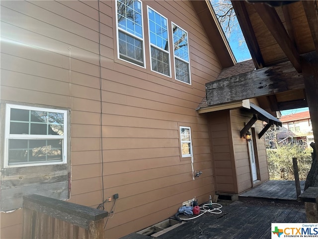 view of side of home featuring a wooden deck