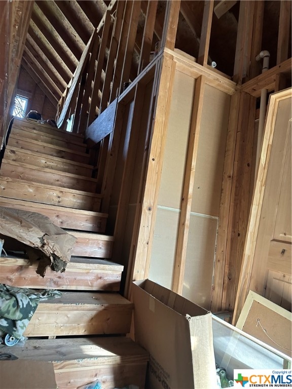 stairway featuring vaulted ceiling