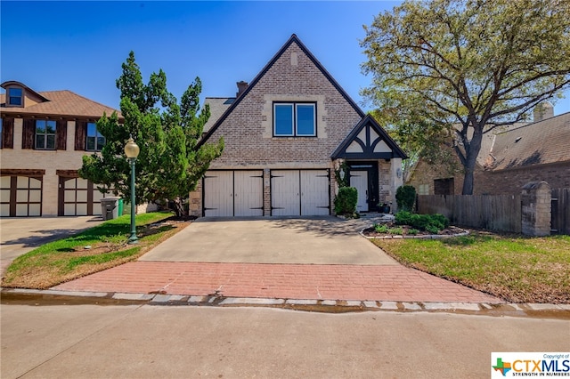 english style home with a garage