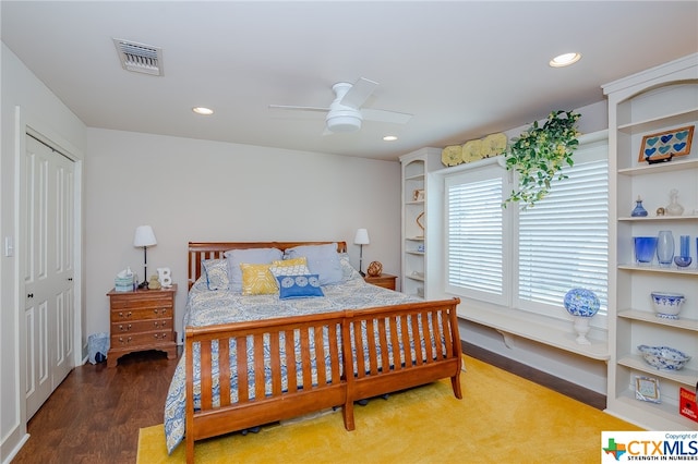 bedroom with a closet, wood-type flooring, and ceiling fan