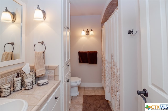 bathroom featuring tile patterned flooring, vanity, and toilet