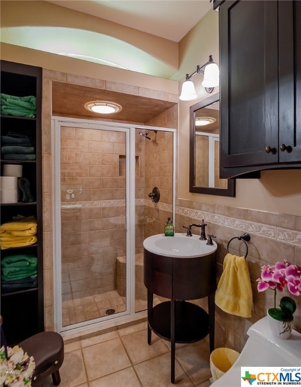 bathroom featuring walk in shower, tile walls, and tile patterned floors