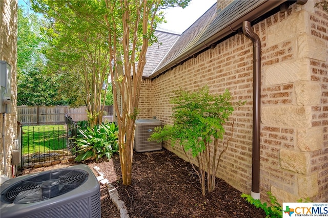 view of side of home with central AC