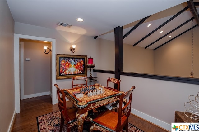 dining room featuring hardwood / wood-style flooring and vaulted ceiling