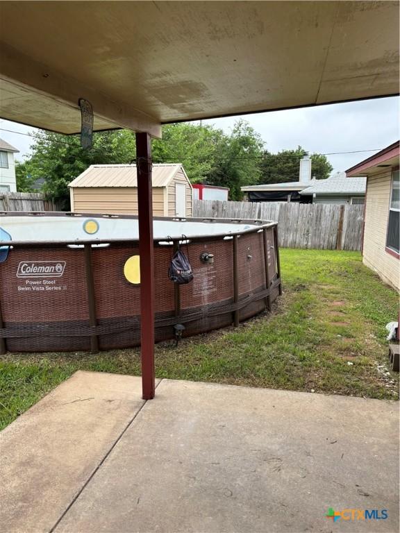 view of patio / terrace with a fenced in pool