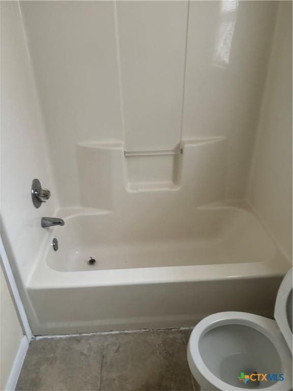 bathroom featuring tub / shower combination and toilet