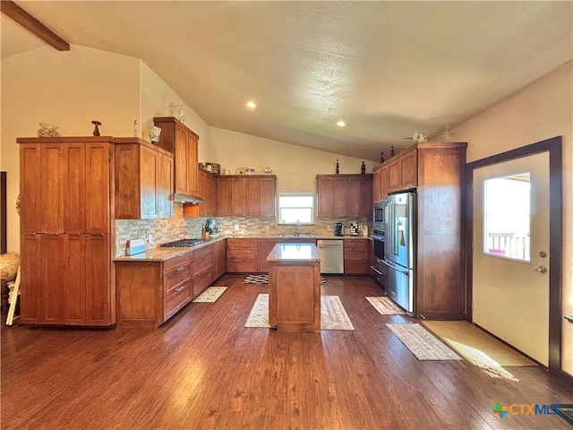 174 Riley Ln, Port Oconnor, TX 77982 - kitchen with appliances with stainless steel finishes, vaulted ceiling, a sink, a center island, and dark wood finished floors