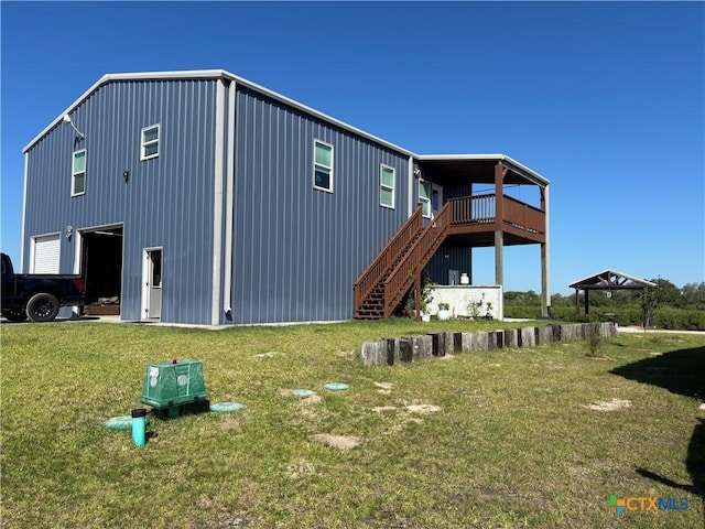 174 Riley Ln, Port Oconnor, TX 77982 - back of house with a yard, stairway, and a garage
