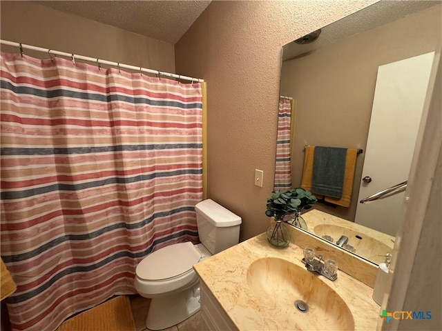 bathroom featuring a textured ceiling, toilet, and vanity