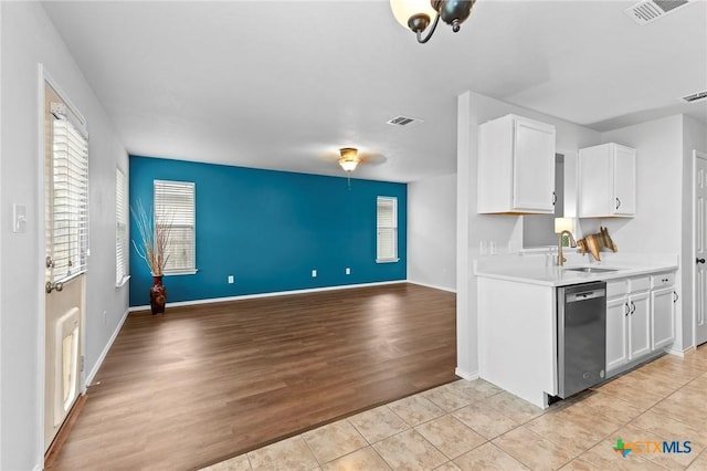 113 Altamont St, Hutto, TX 78634 - kitchen with dishwasher, a sink, open floor plan, white cabinetry, and light countertops