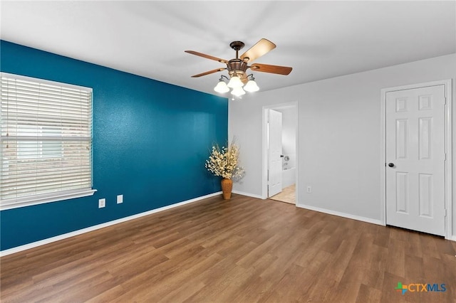 113 Altamont St, Hutto, TX 78634 - spare room featuring wood finished floors, ceiling fan, and baseboards