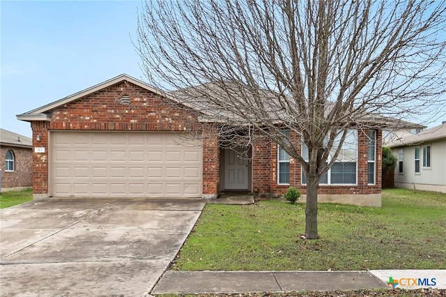 113 Altamont St, Hutto, TX 78634 - ranch-style house with brick siding, a front lawn, and driveway