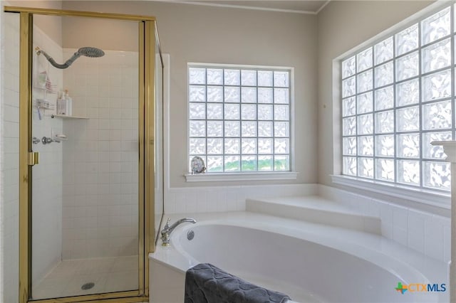 bathroom featuring separate shower and tub