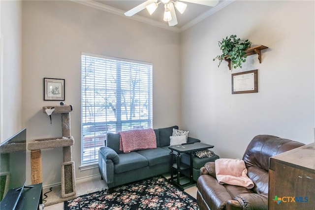 living room featuring crown molding, ceiling fan, and carpet floors