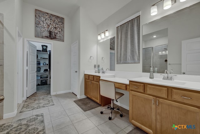 bathroom featuring walk in shower, vanity, and tile patterned floors