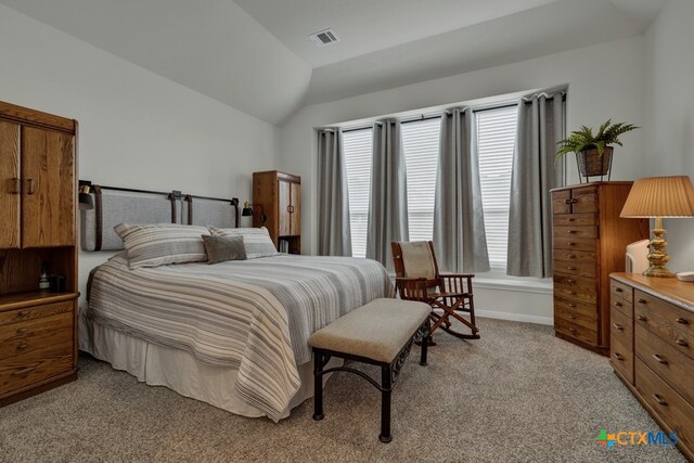 carpeted bedroom featuring vaulted ceiling