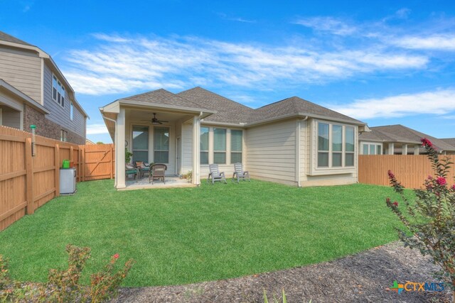 rear view of house featuring a lawn, ceiling fan, and a patio area