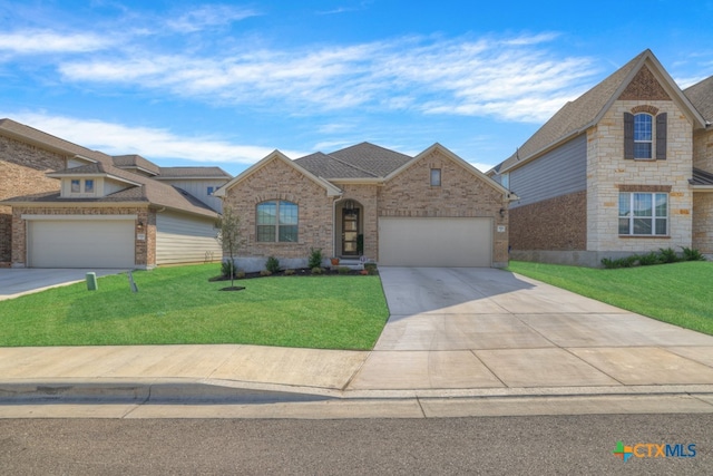 view of front of house with a garage and a front yard