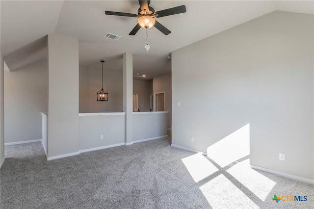 carpeted spare room featuring ceiling fan and vaulted ceiling