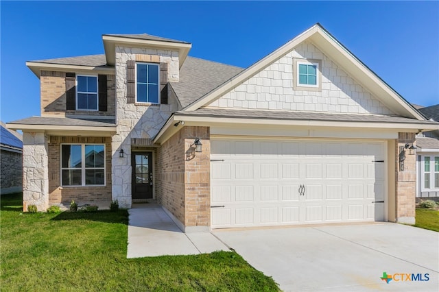 view of front of property featuring a front yard and a garage