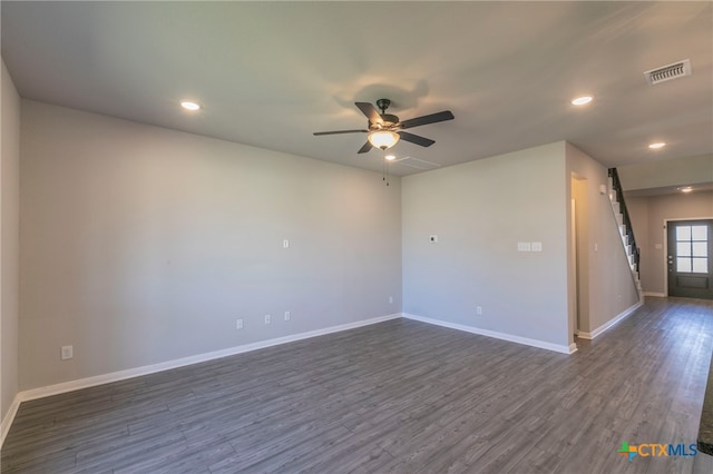 spare room with ceiling fan and dark hardwood / wood-style flooring