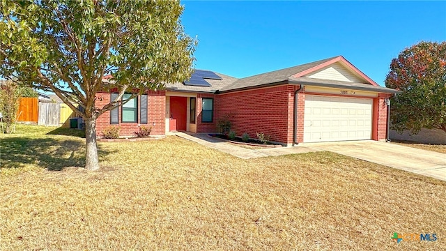 ranch-style house with solar panels, a garage, a front yard, and central AC