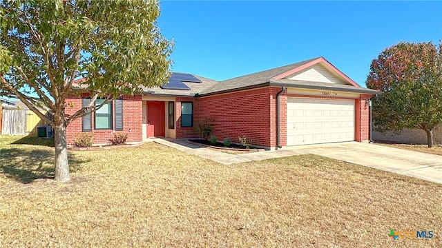 ranch-style home with central AC, a garage, a front yard, and solar panels