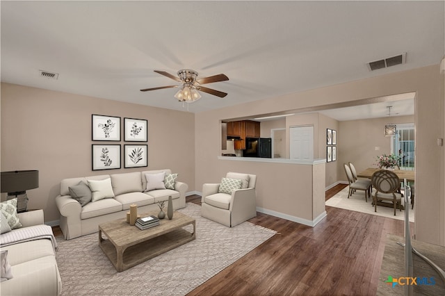 living room with hardwood / wood-style floors and ceiling fan