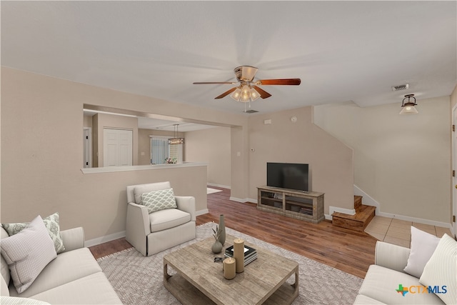 living room featuring light hardwood / wood-style floors and ceiling fan