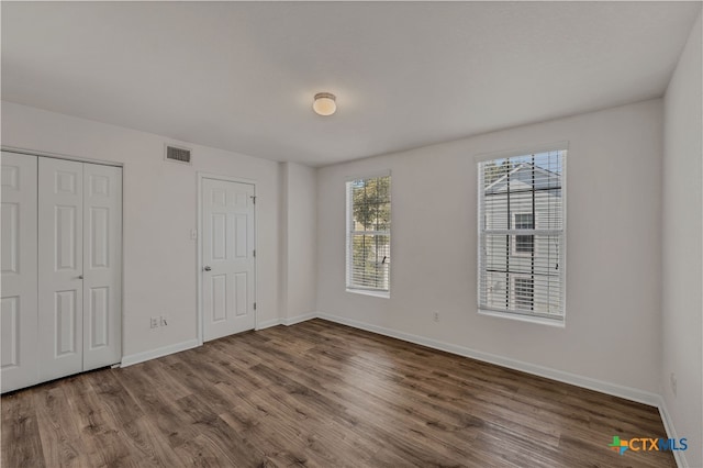 unfurnished bedroom with wood-type flooring