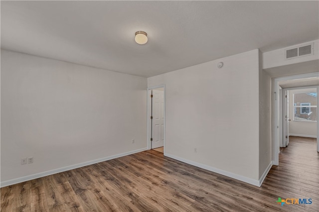 unfurnished room featuring hardwood / wood-style flooring