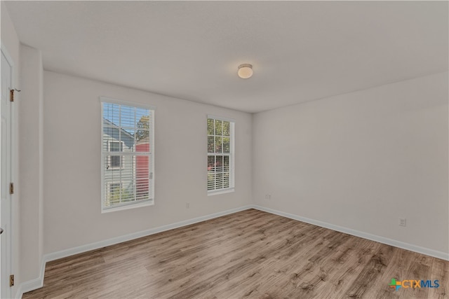 spare room featuring light hardwood / wood-style floors