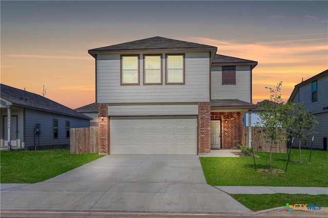 front facade with a garage and a lawn