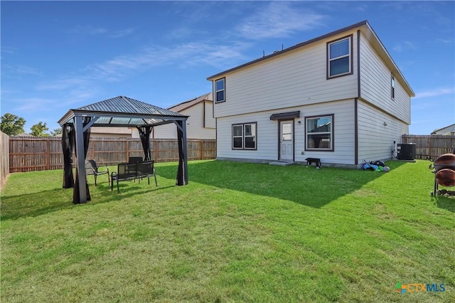 2425 Marty Way, Seguin, TX 78155 - rear view of property featuring a gazebo, a fenced backyard, and an outdoor fire pit