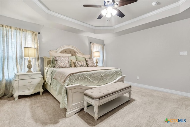 bedroom with crown molding, ceiling fan, a tray ceiling, and carpet floors