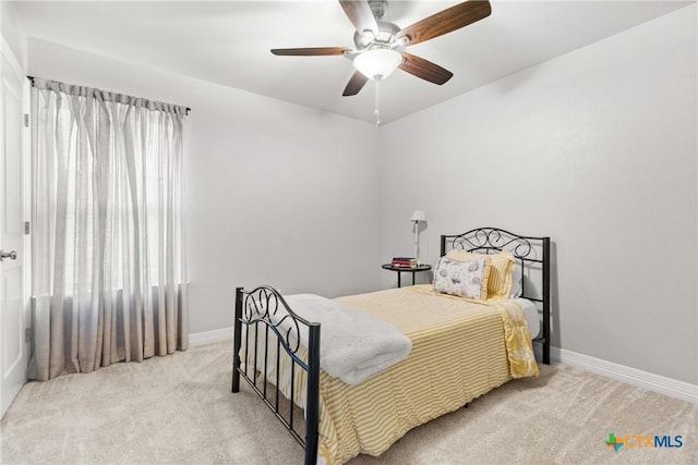 bedroom with multiple windows, light carpet, and ceiling fan