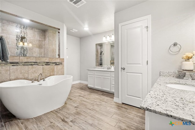 bathroom with vanity and a bathtub