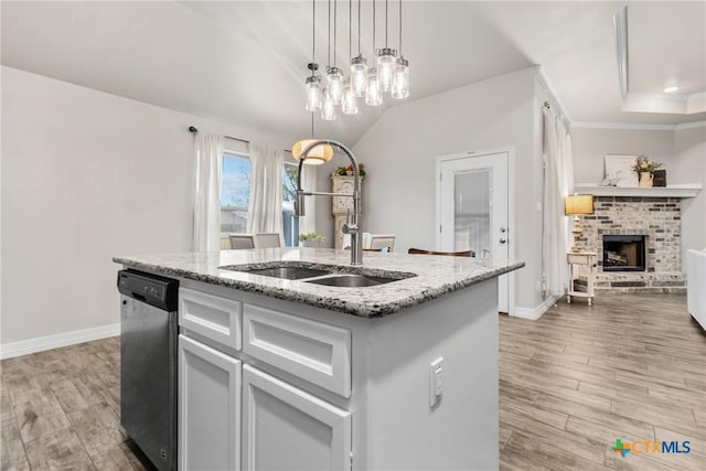 kitchen featuring white cabinetry, sink, dishwasher, and a kitchen island with sink