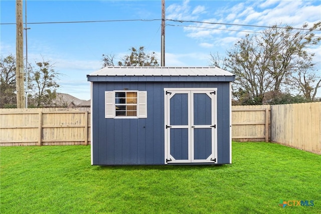 view of outbuilding featuring a lawn